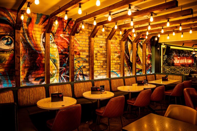 Trendy restaurant interior with graffiti brick wall