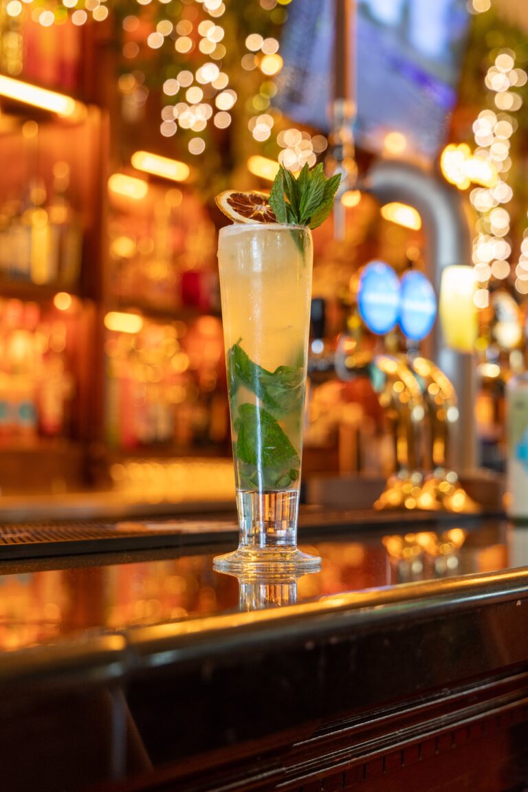 Mint cocktail in tall glass on bar counter