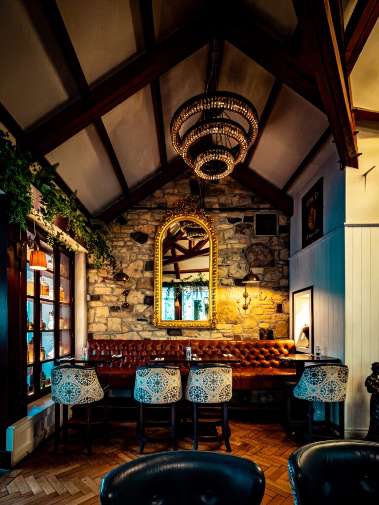 Cosy restaurant interior with stone wall and chandelier
